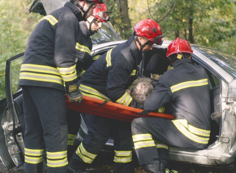 Firefighters extracting a driver from a wrecked vehicle